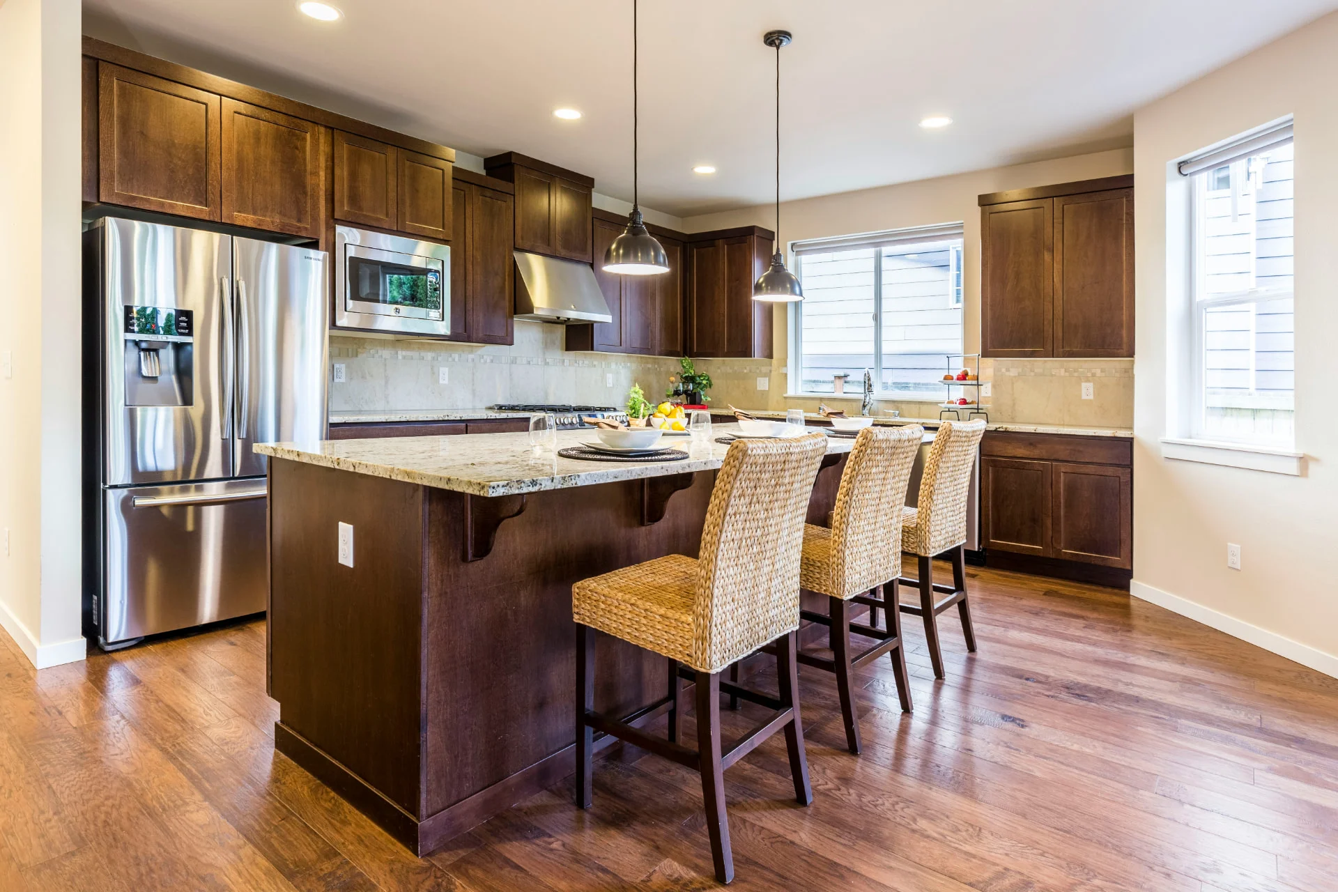 Dark walnut hardwood floor in a bright kitchen with espresso cabinetry